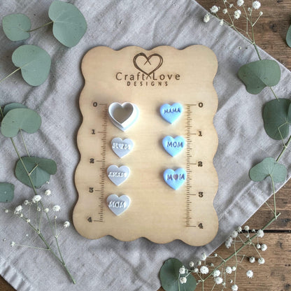 multiple heart clay charms with mom and mama words on Craft Love ruler board