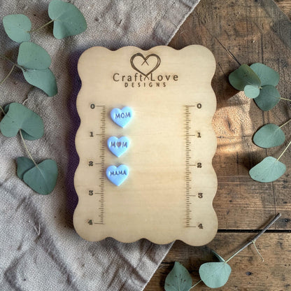 three finished heart clay charms with mom mama word emboss design