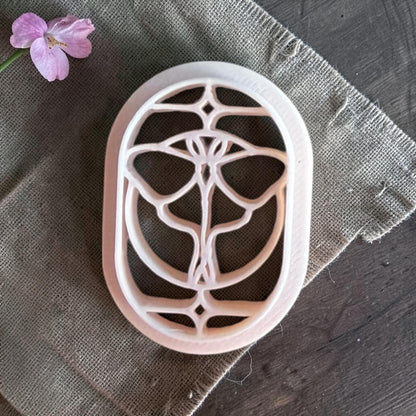 Beige butterfly cutter with a geometric wing pattern stained glass effect