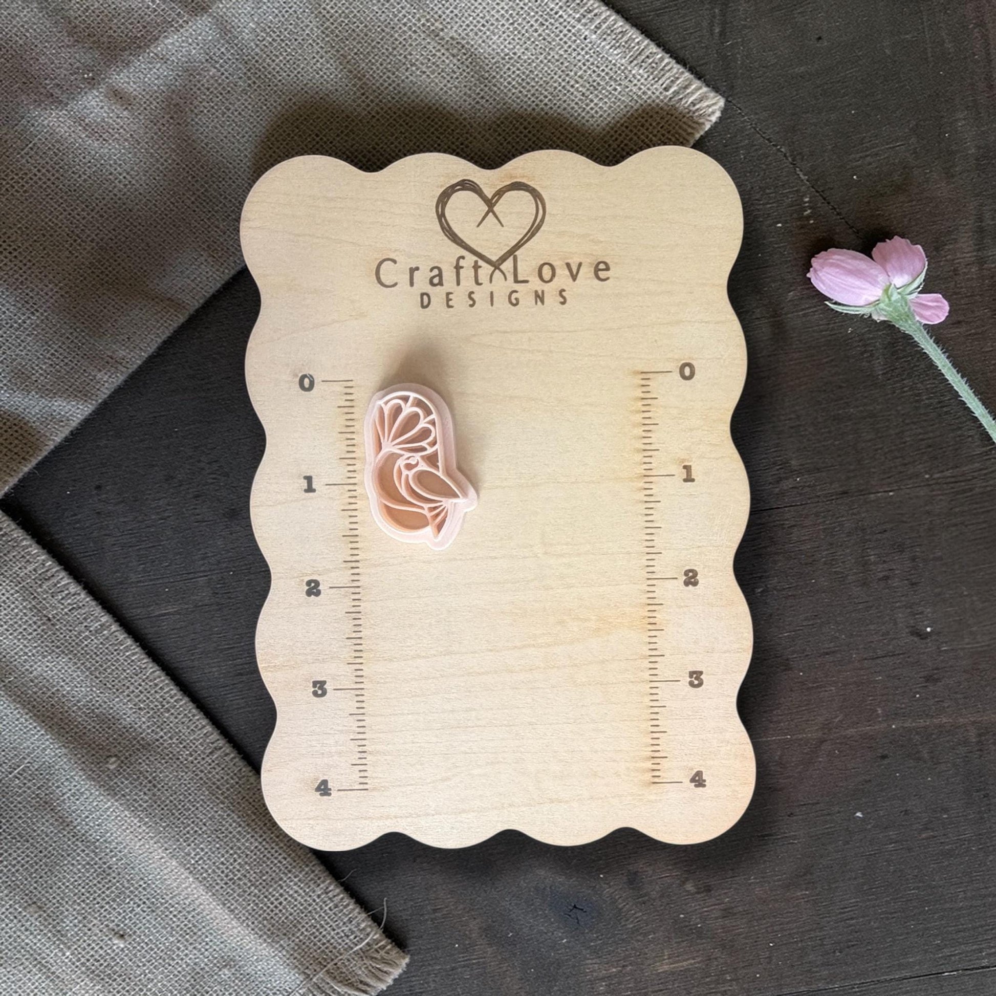 Beige bird under flower cutter.