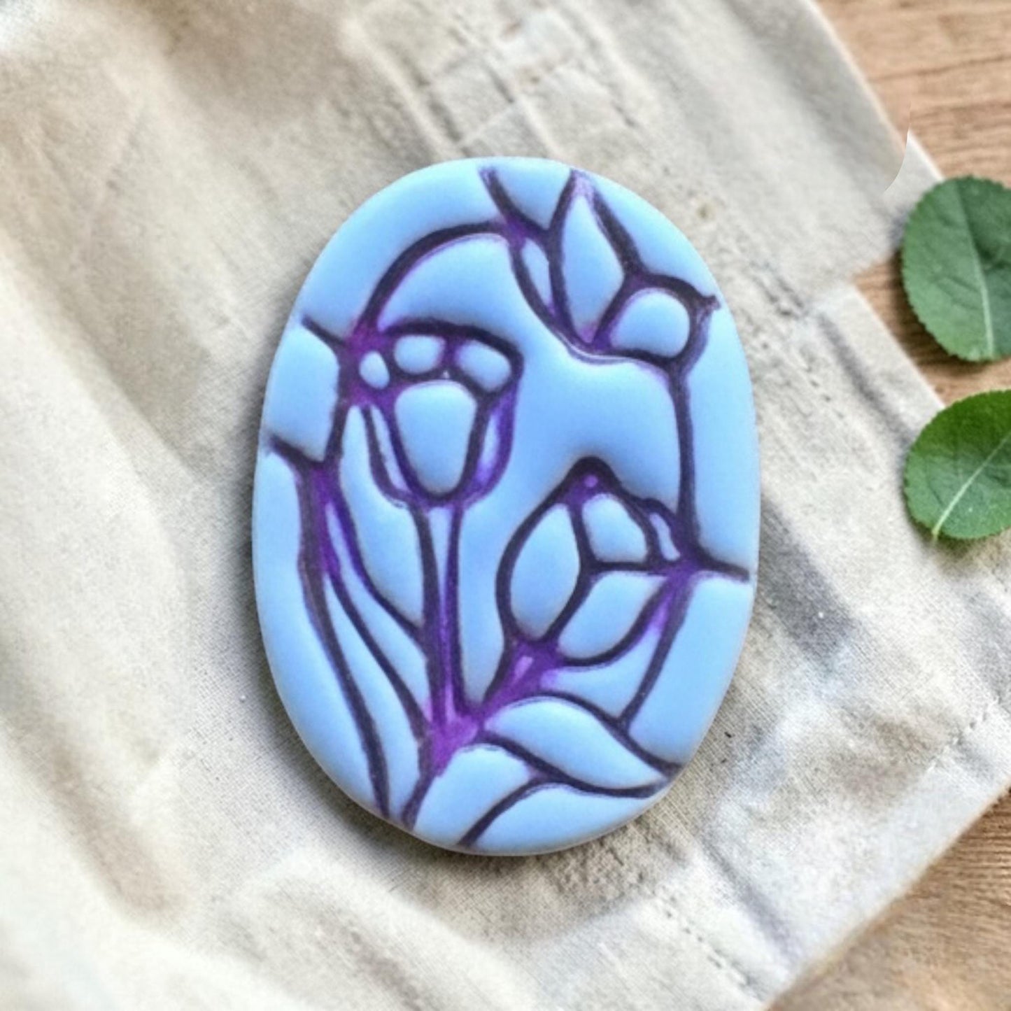 Close up of tulips and butterfly clay piece.