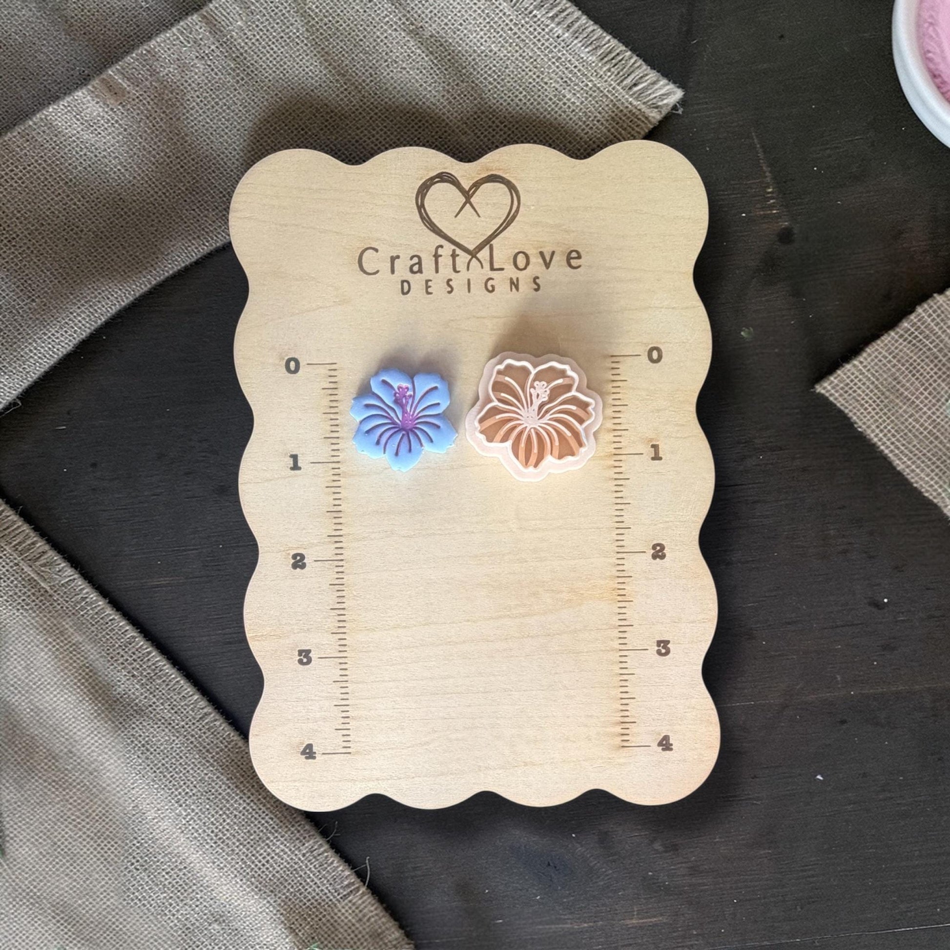 Hibiscus clay cutter next to finished clay piece.