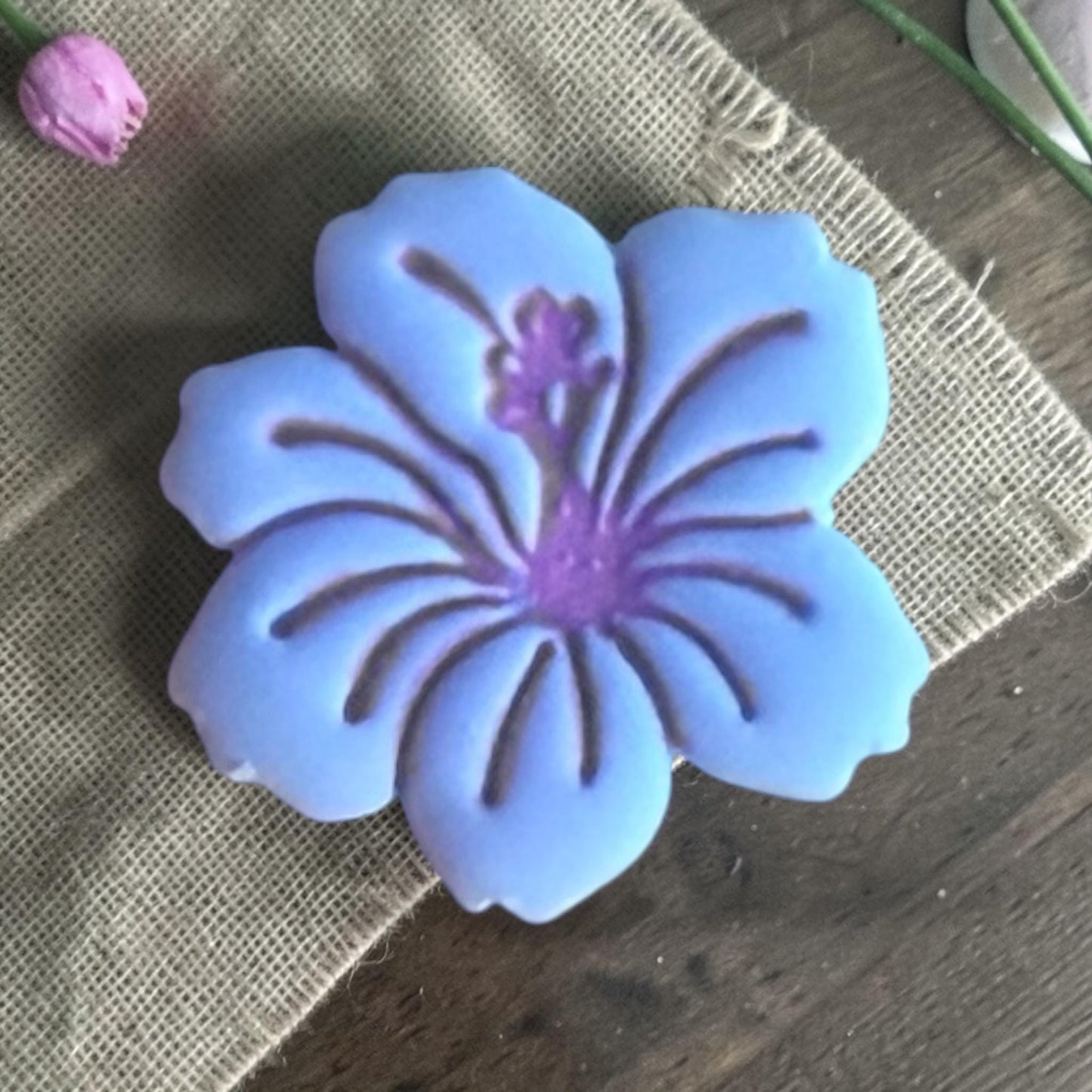 Close up of hibiscus clay piece.