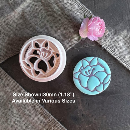 Poppy flower clay cutter next to finished clay piece.