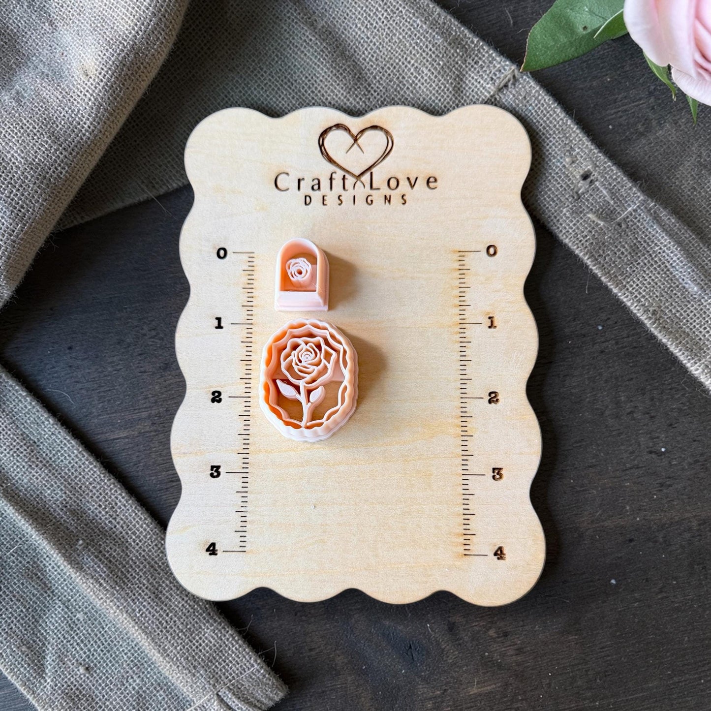 rose cameo cutter and small rose cutter on wooden sizing board