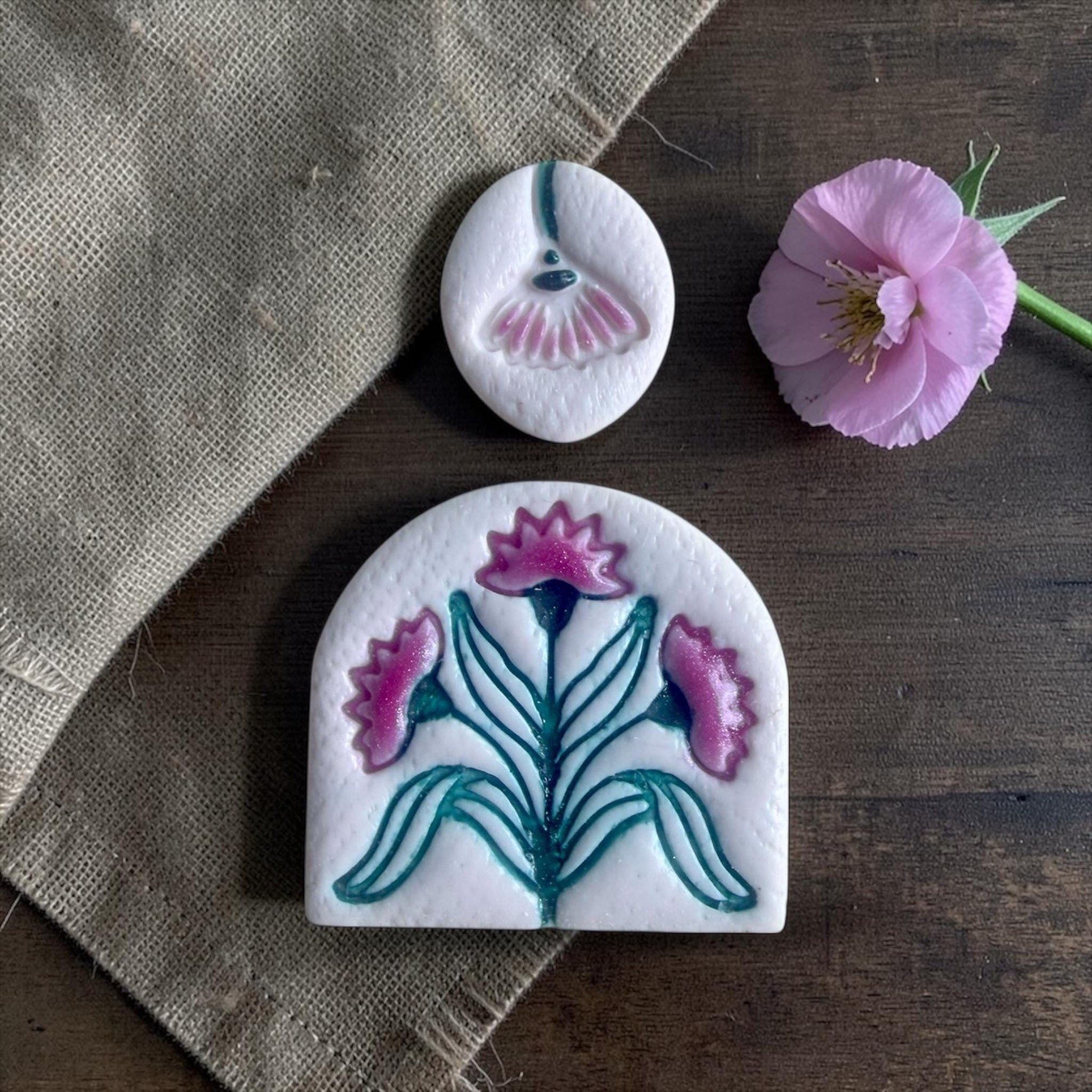 floral clay imprints from arch cutter and topper displayed with pink flower