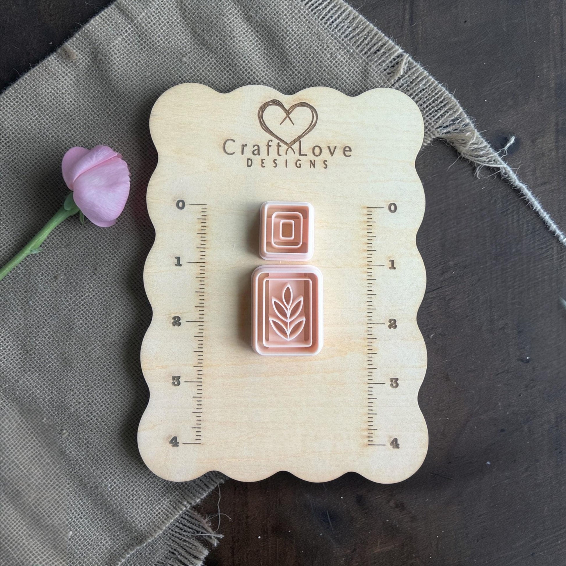 square topper cutter and leaf rectangle cutter arranged on wooden sizing board
