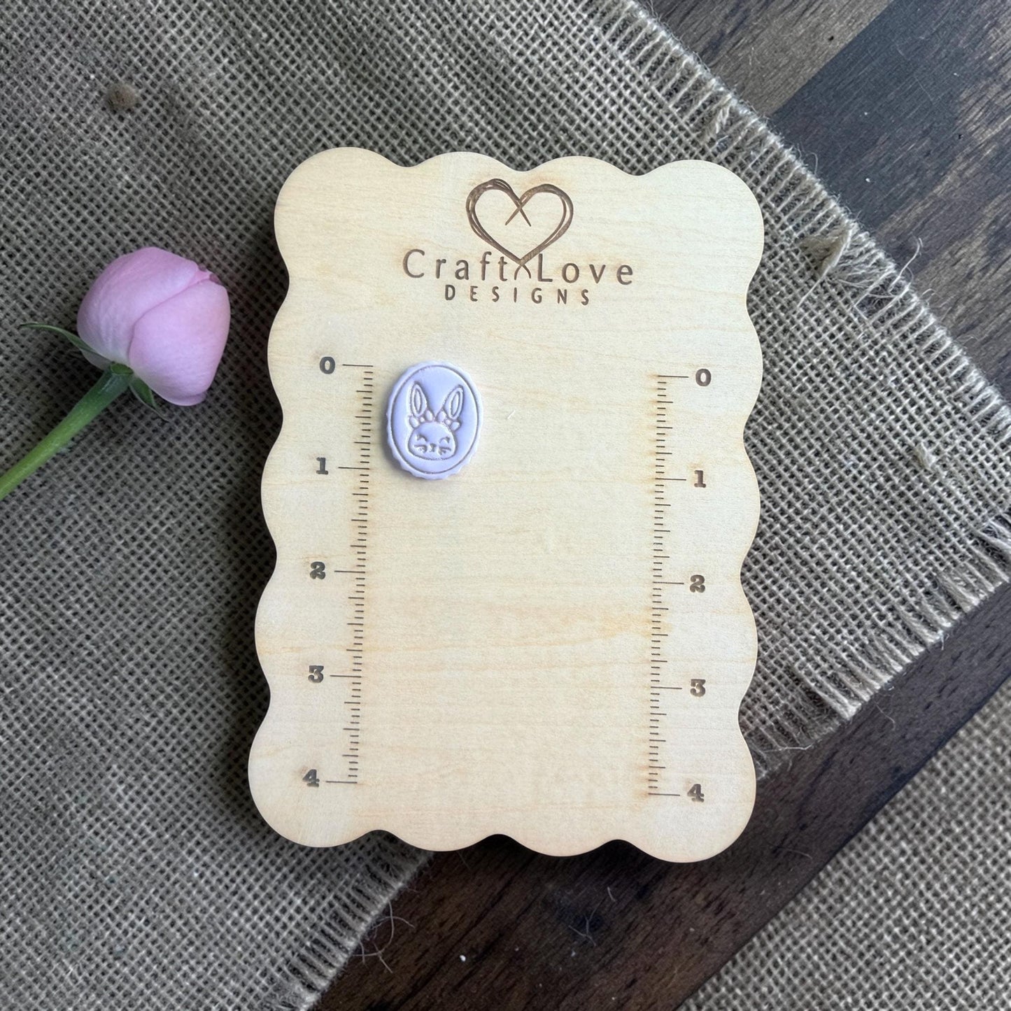 purple clay imprint showing bunny cameo on burlap