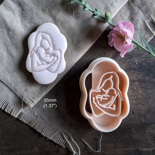 Mother and baby cutter with matching clay imprint, size shown 35mm (1.37"), on burlap