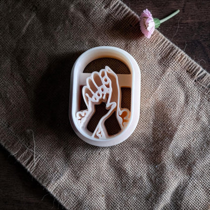 motherhood clay cutter with baby hand design example