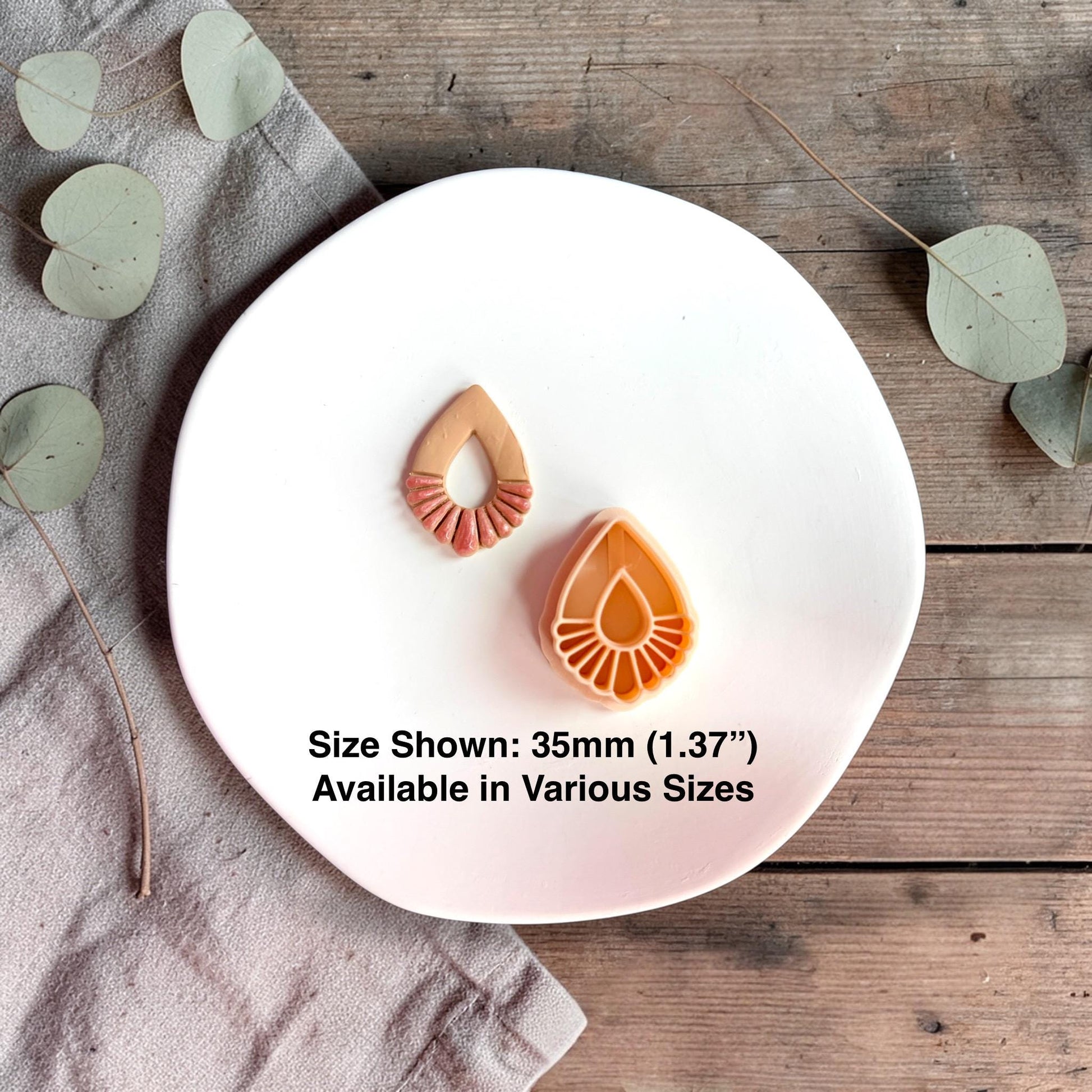Finished clay piece and cutter side by side with text showing size 35mm on a white plate.