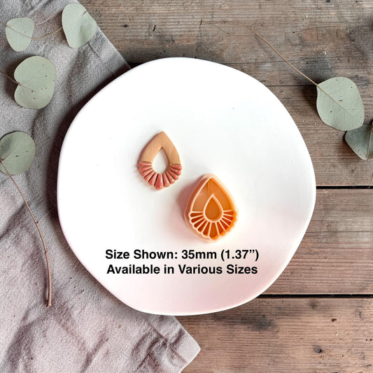 Finished clay piece and cutter side by side with text showing size 35mm on a white plate.