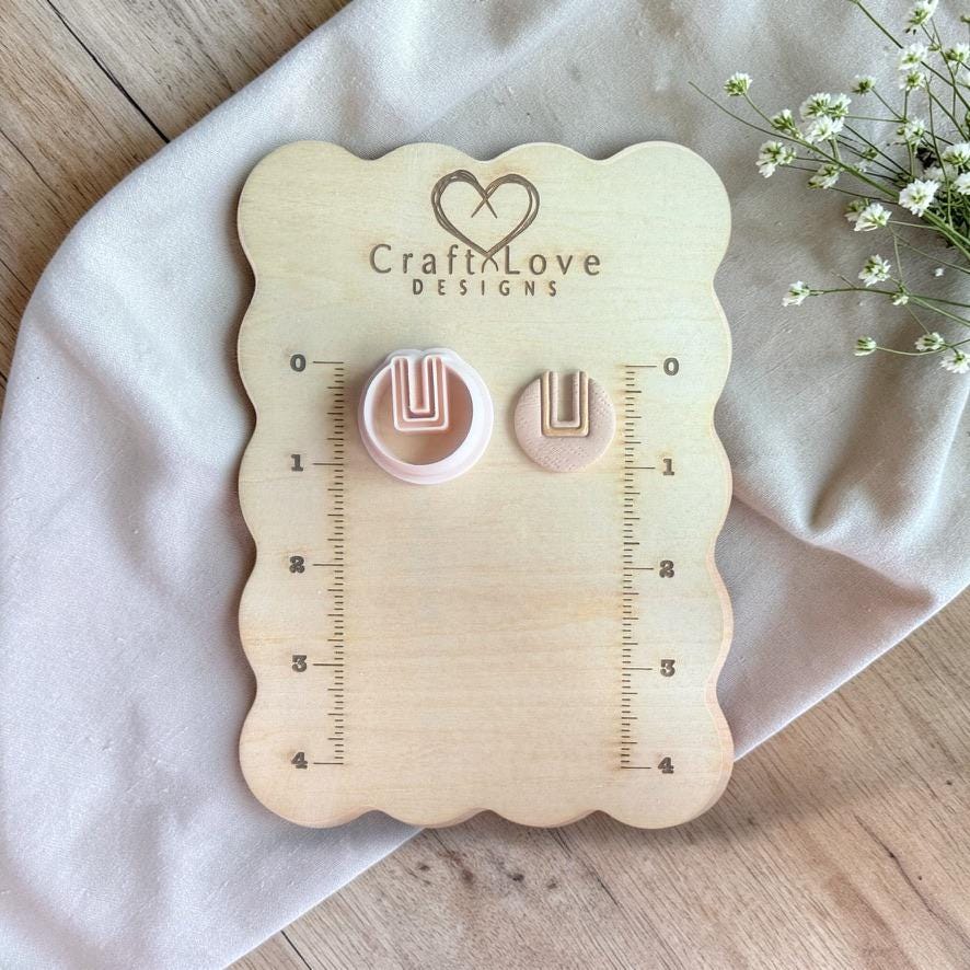 U cutout round cutter and clay piece shown on Craft Love Designs board