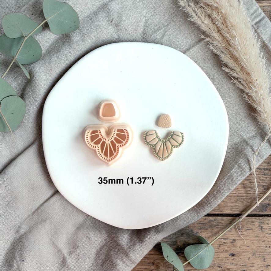 Cutter and finished clay earrings side by side with text showing size 35mm on a white plate.