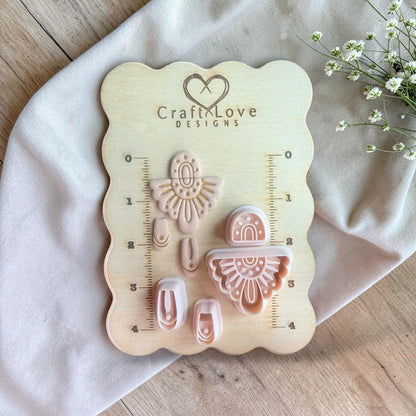 Full cutter set and finished pieces displayed on a wooden measuring board with ruler markings and brand logo.