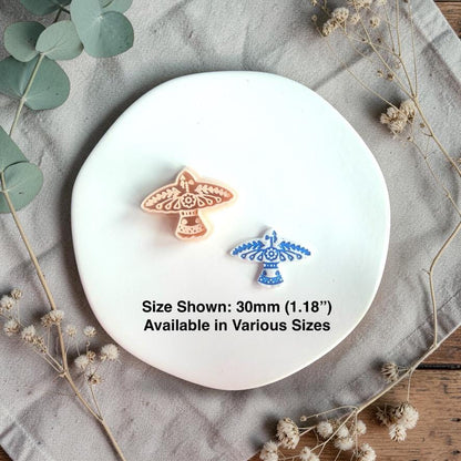 Two clay pieces and cutter displayed together with size text 30mm on a white plate with dried flowers.