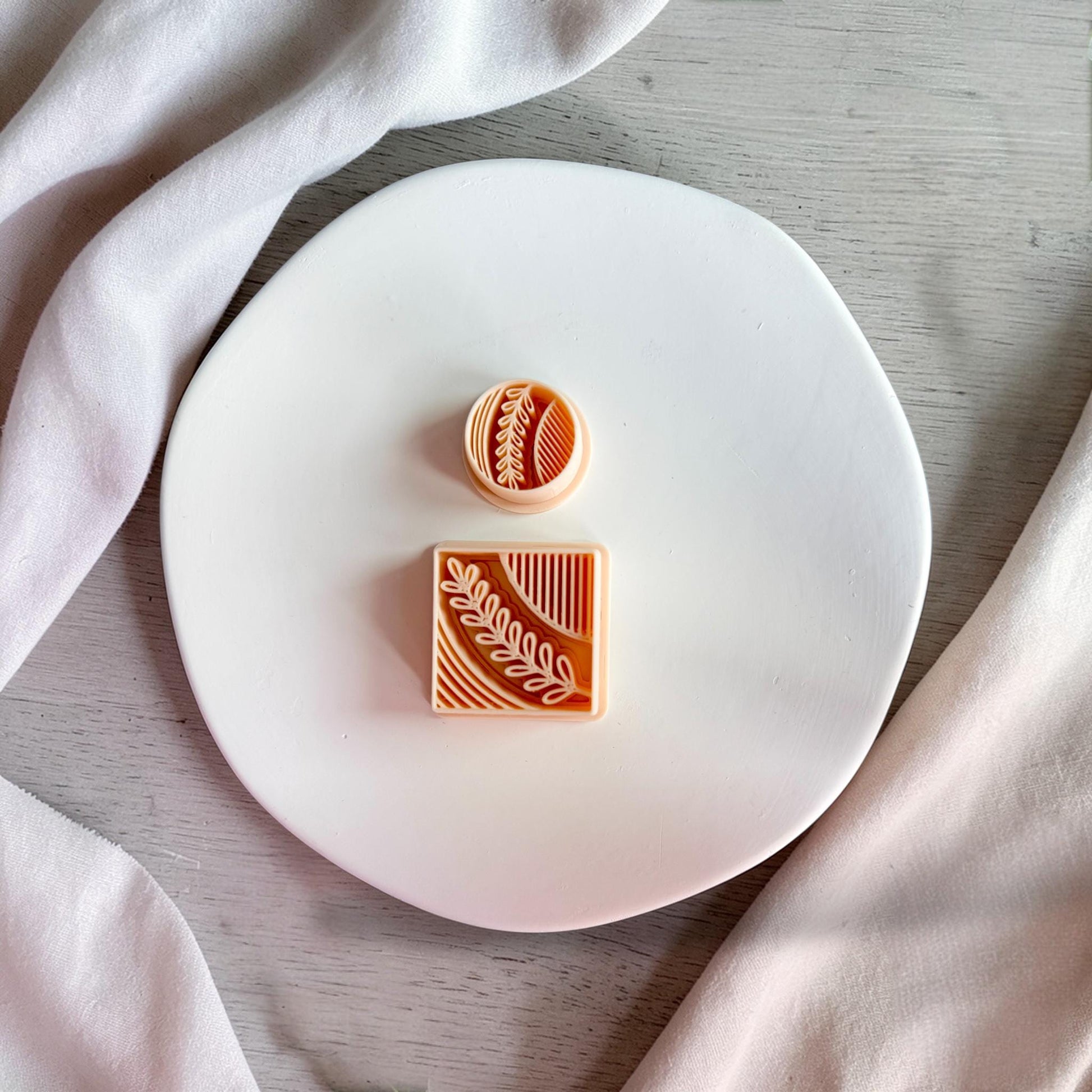 Botanical leaf polymer clay cutter on white plate