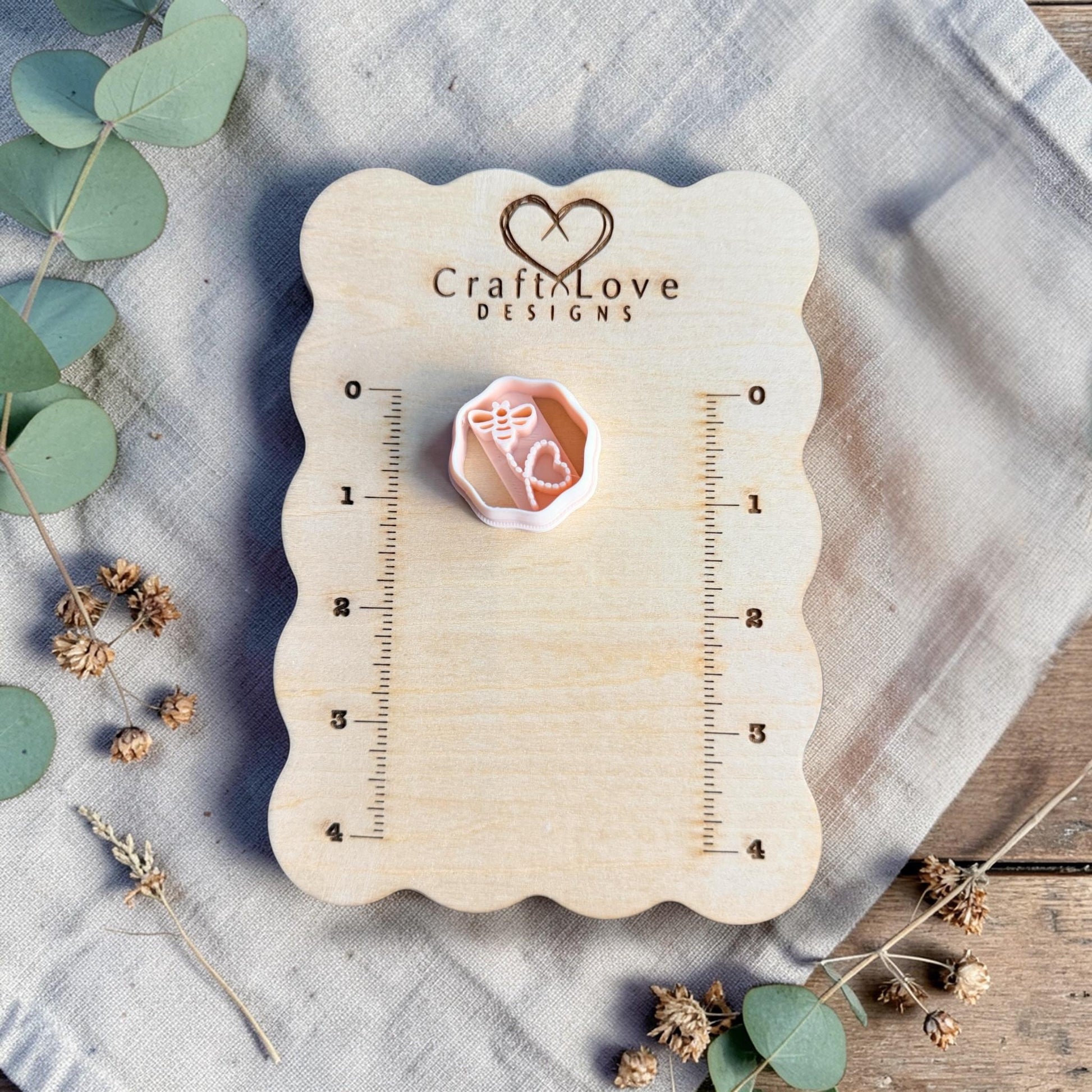 bee heart clay cutter on measuring board close view