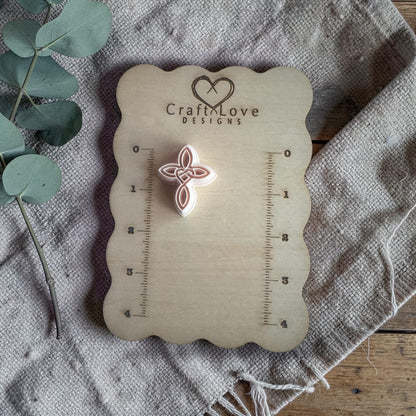 celtic heart cross polymer clay cutter on measuring board