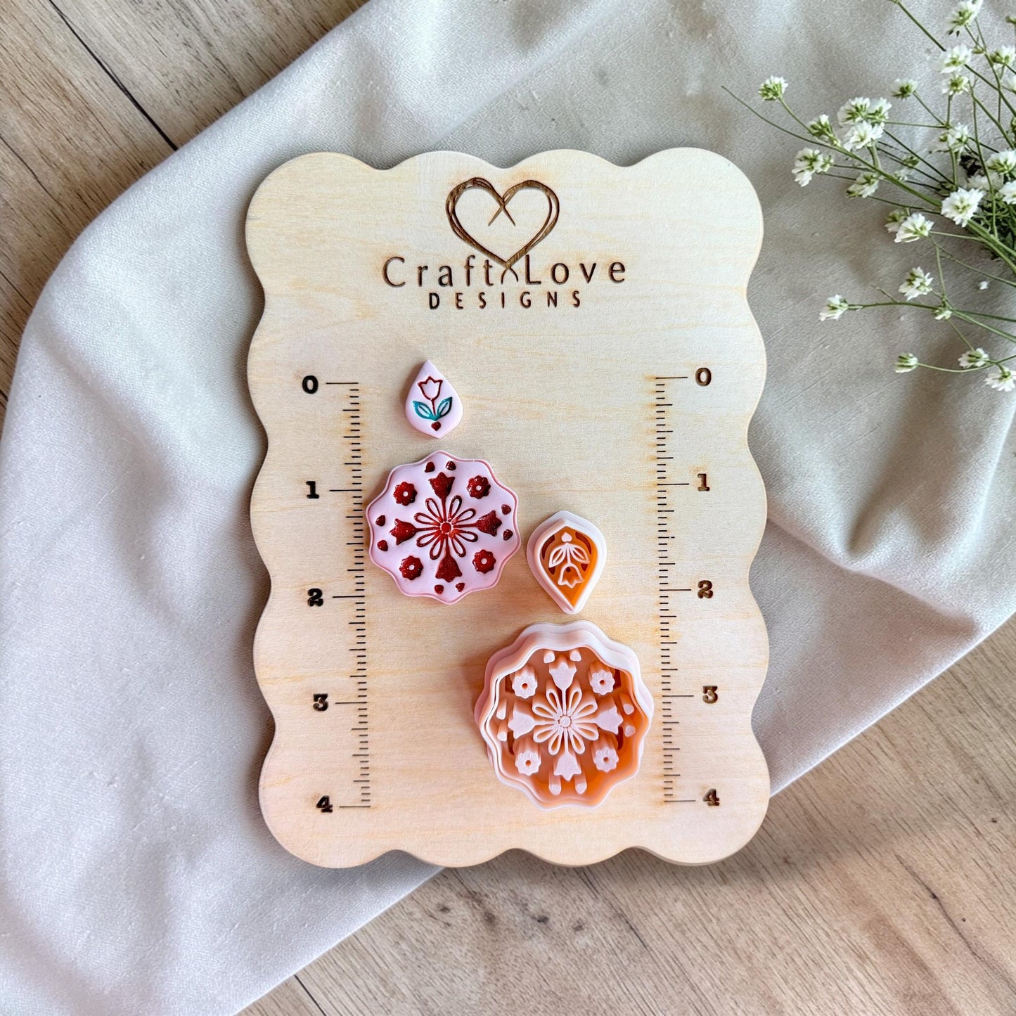 Mandala polymer clay cutter displayed on wooden measurement board with sizing grid