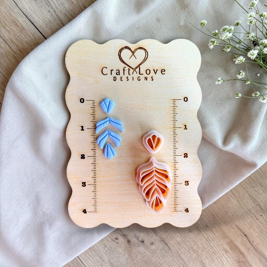 Fern leaf polymer clay cutter displayed on measurement board showing size and scale