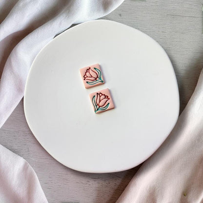 Finished clay earrings using tulip floral cutter showing rotated design variation