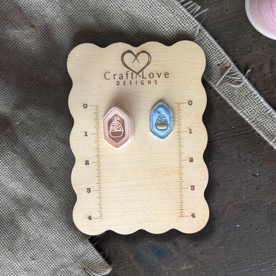 Pink and blue sailboat clay pieces shown side by side for color variation