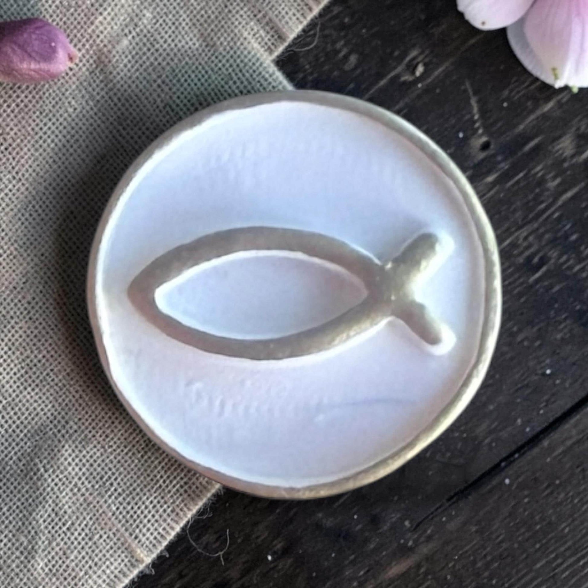 Finished white clay charm with debossed Christian fish symbol