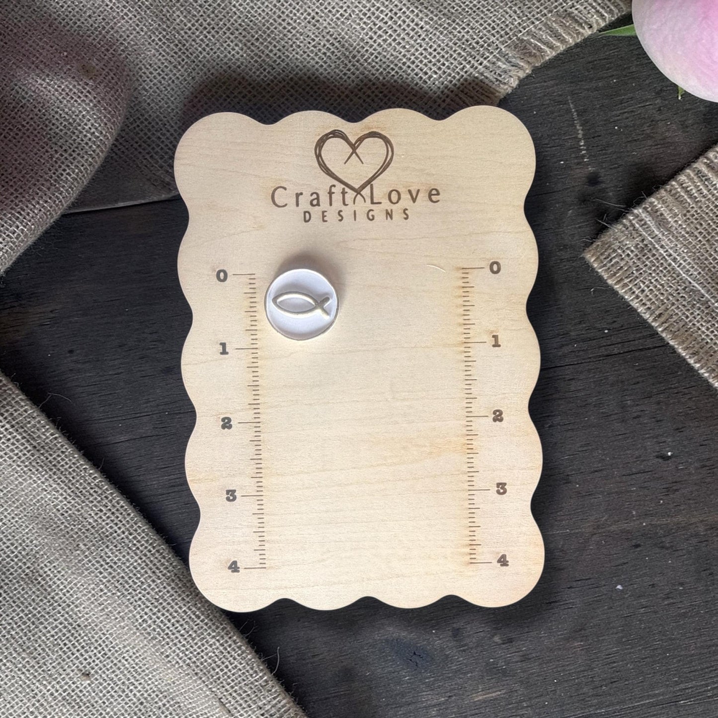 Polymer clay cutter with Ichthys fish placed on Craft Love Designs ruler board for size reference