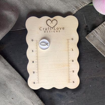 Polymer clay cutter with Ichthys fish placed on Craft Love Designs ruler board for size reference