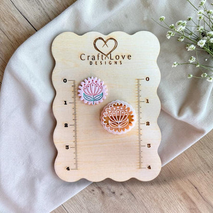 Scandinavian floral polymer clay cutter shown on measurement board for size reference