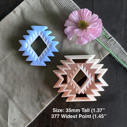 Aztec clay cutter and finished blue clay aztec charm with size text