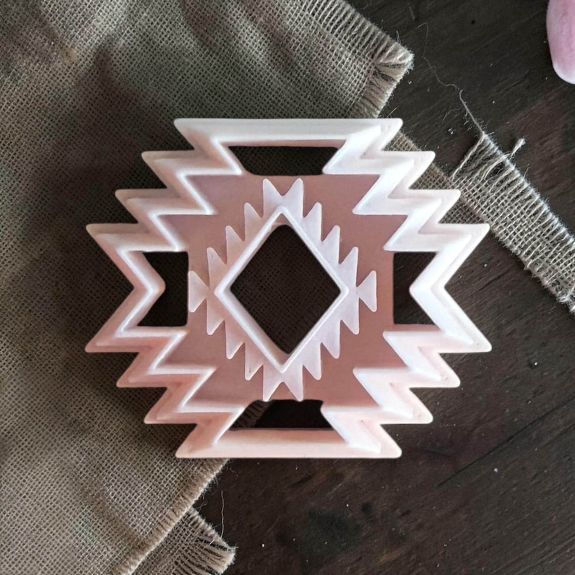 Southwestern aztec pattern polymer clay cutter on burlap fabric