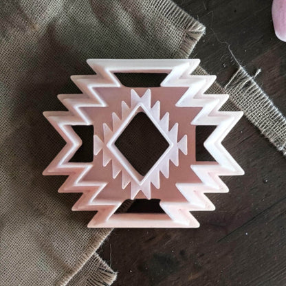 Southwestern aztec pattern polymer clay cutter on burlap fabric