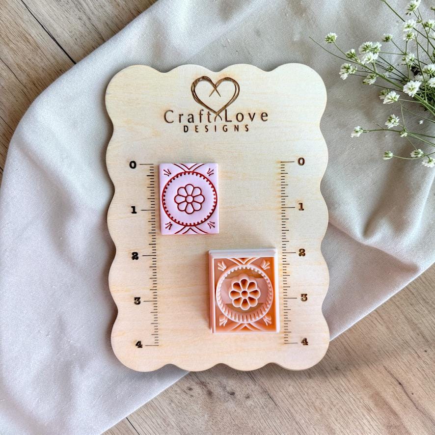 Square geometric flower polymer clay cutter on wooden sizing board