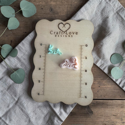 two clay rabbit charms on Craft Love Designs ruler board showing scale