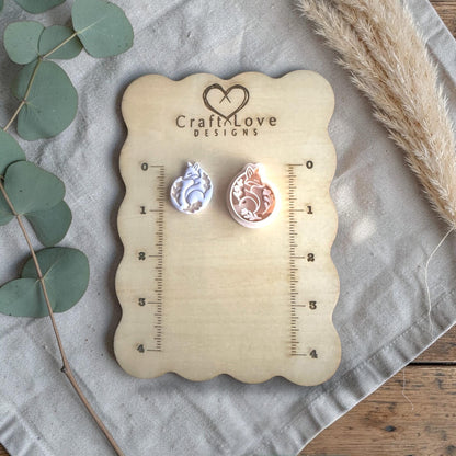 two finished fox clay charms displayed on Craft Love Designs ruler board