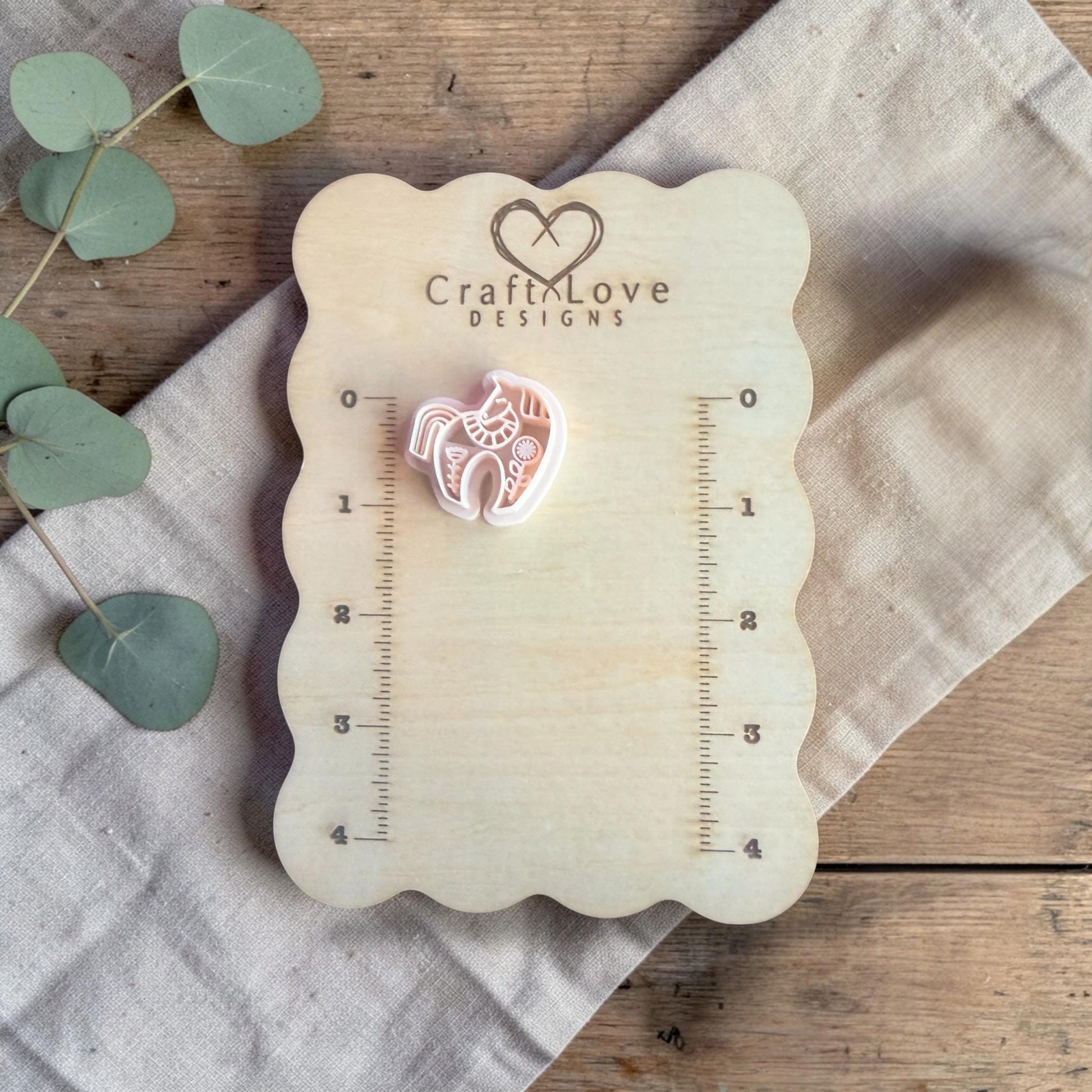 white polymer clay horse cutter displayed on Craft Love Designs ruler board