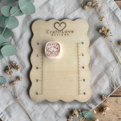 white polymer clay flower cutter displayed on Craft Love Designs ruler board