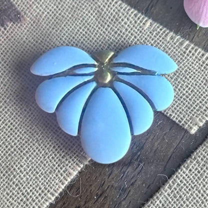 finished blue clay flower charm showing embossed petal lines