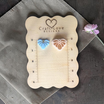 blue flower clay charm and cutter displayed on ruler board