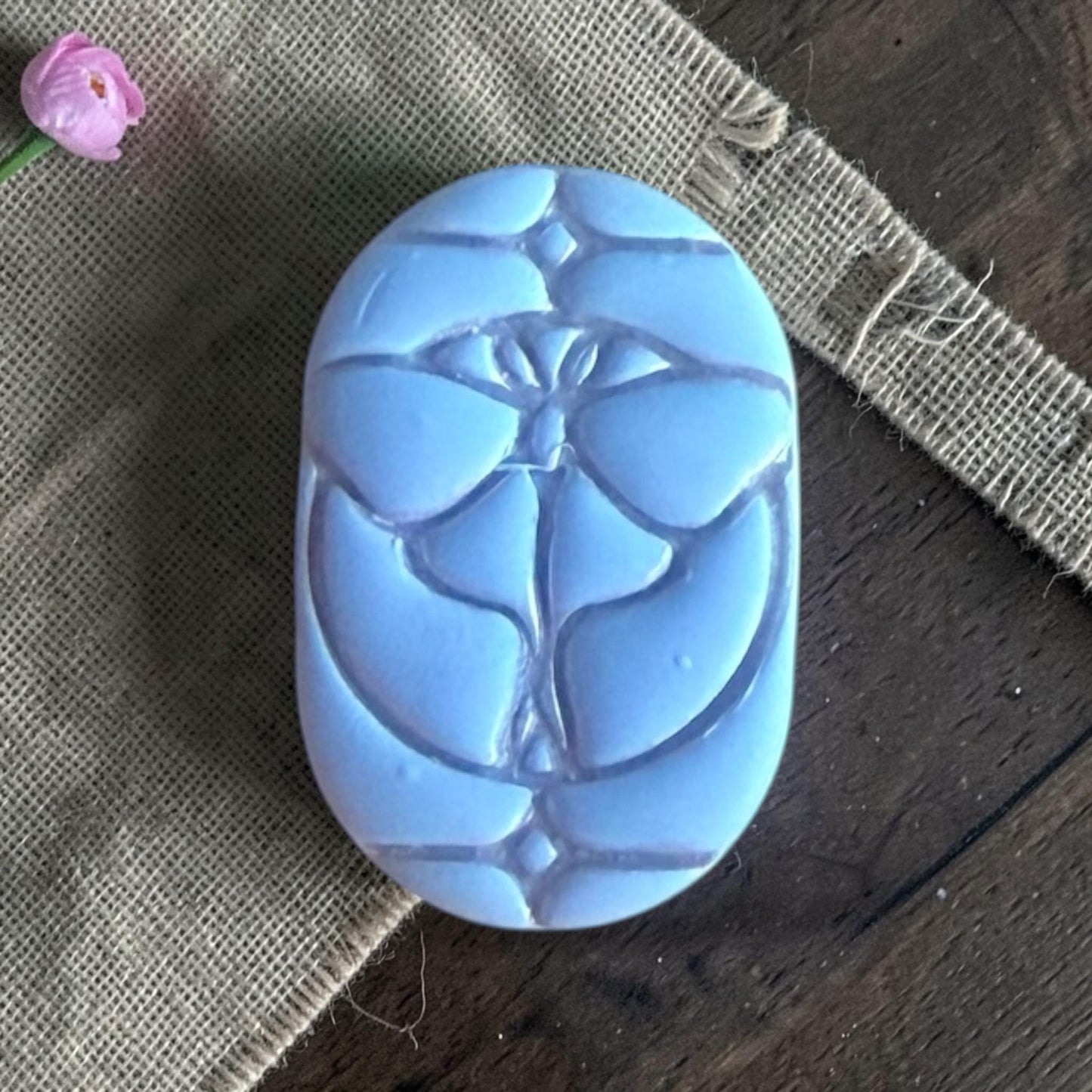 Close-up of a butterfly stained glass clay piece.