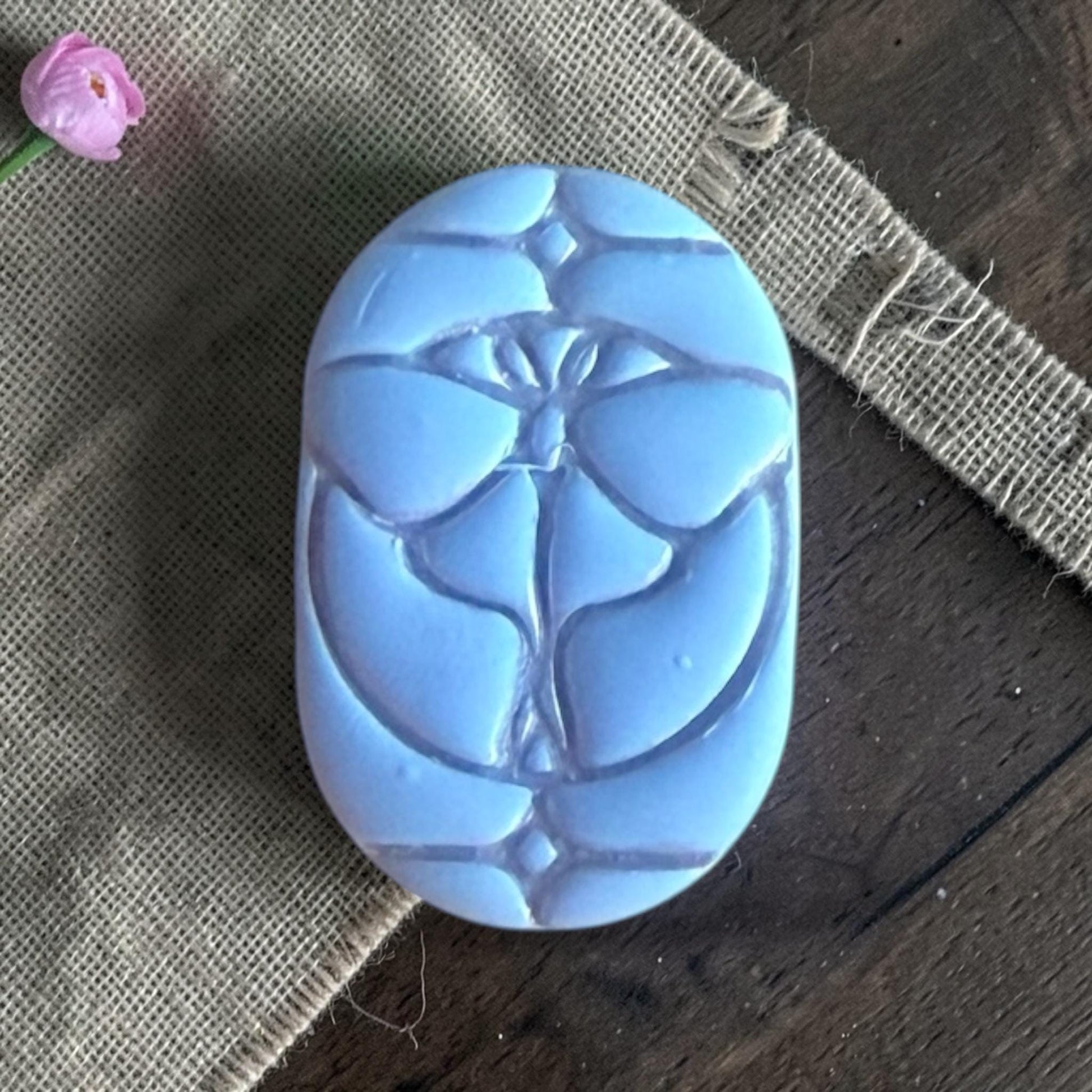Close-up of a butterfly stained glass clay piece.
