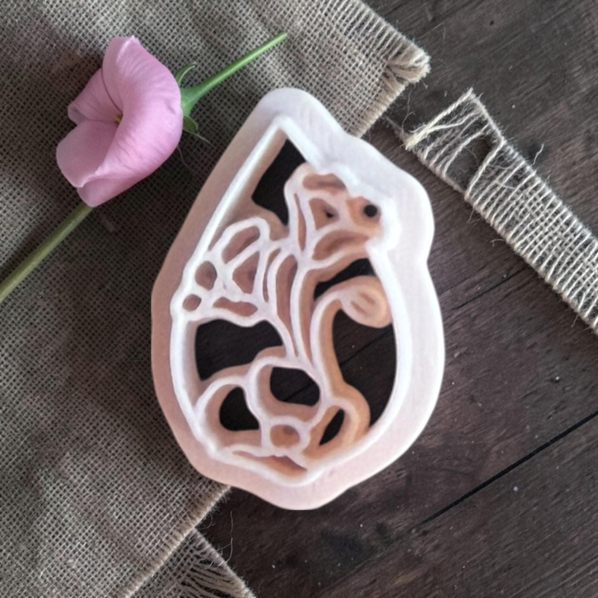 Beige teardrop flower cutter.