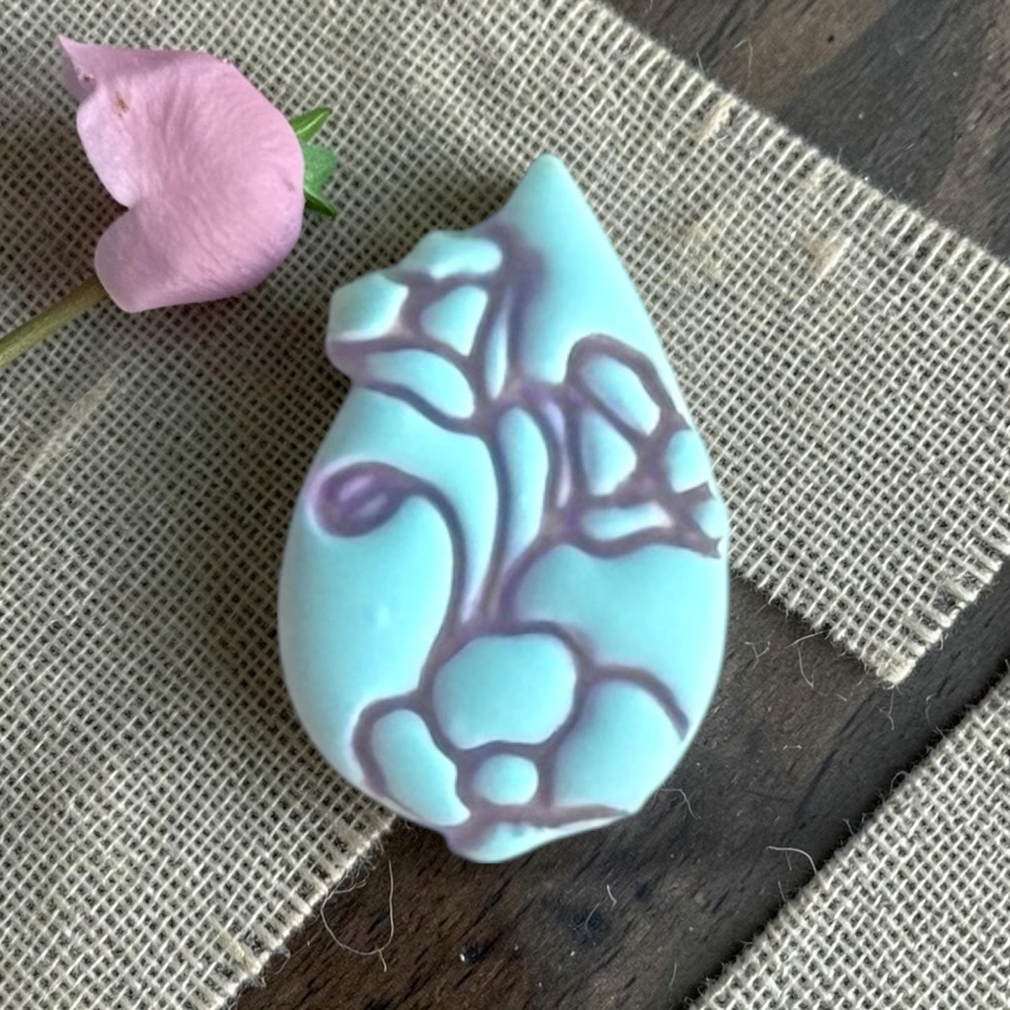Close up of teardrop flower clay piece.