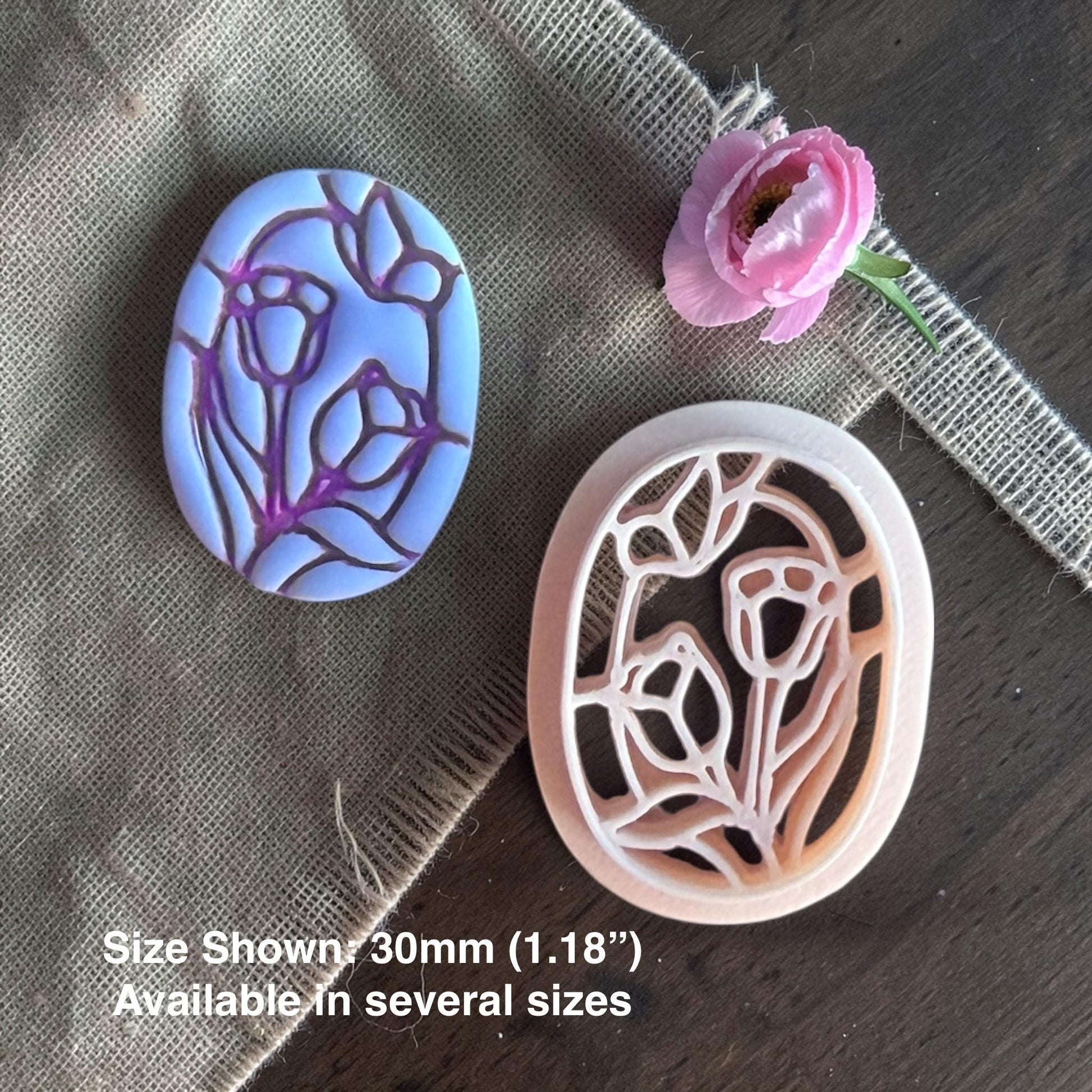 Tulips and butterfly clay cutter next to finished clay piece.