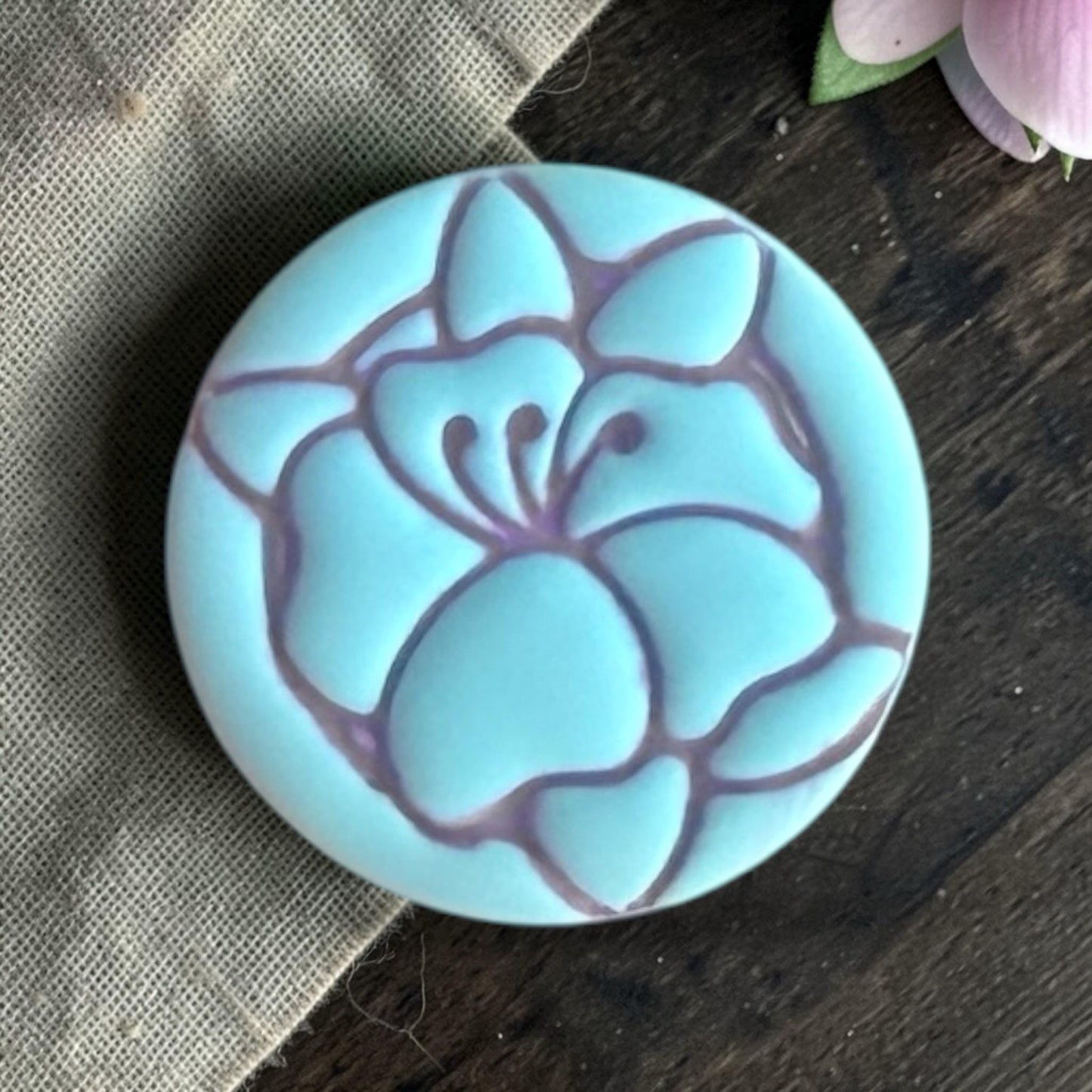 Close up of poppy flower clay piece.