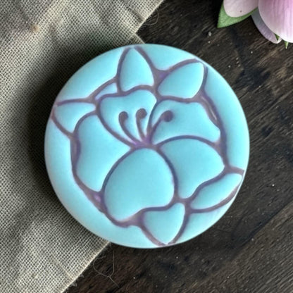 Close up of poppy flower clay piece.