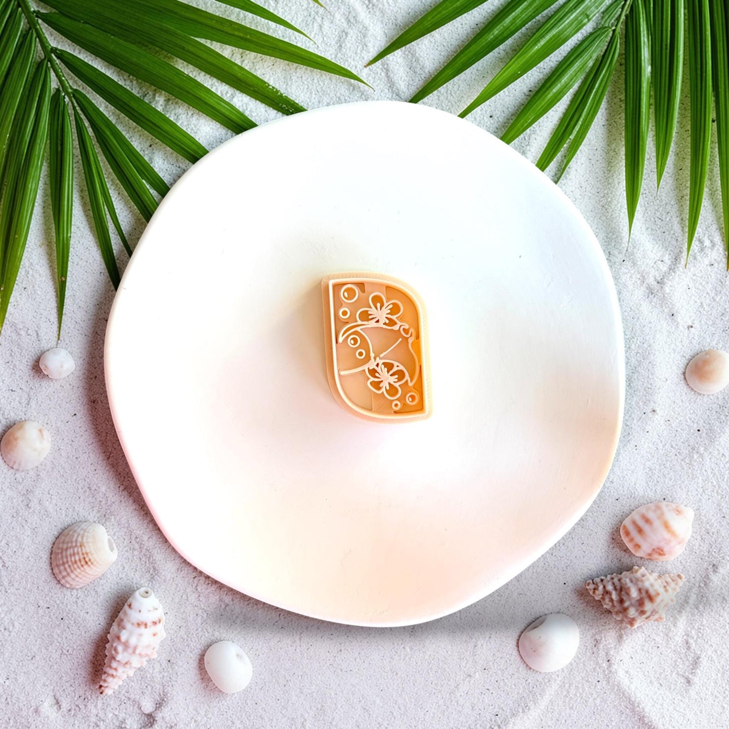 Close up of ocean themed stingray clay cutter with floral pattern for earring making