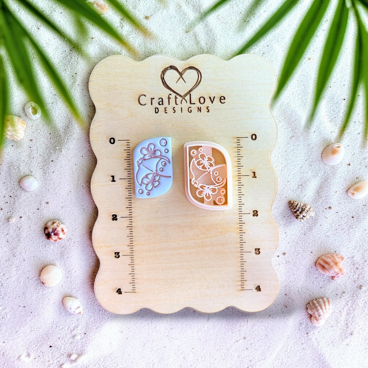 Polymer clay cutter displayed on measurement board showing scale for stingray earring design